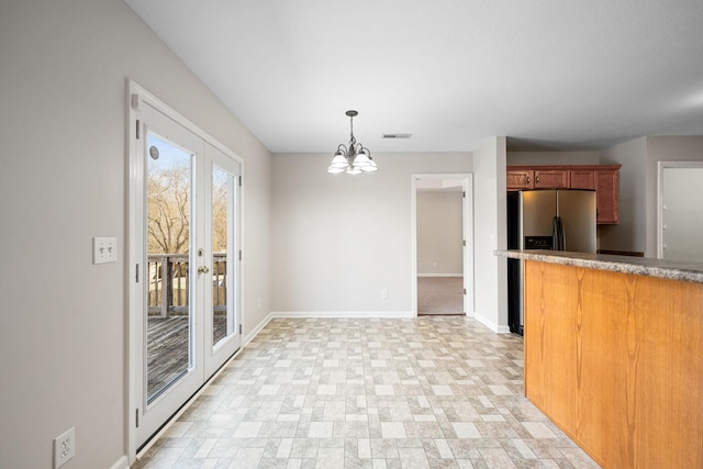 kitchen with french doors, brown cabinets, pendant lighting, stainless steel fridge with ice dispenser, and baseboards