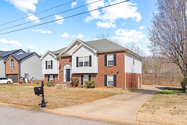 raised ranch featuring brick siding and a front lawn