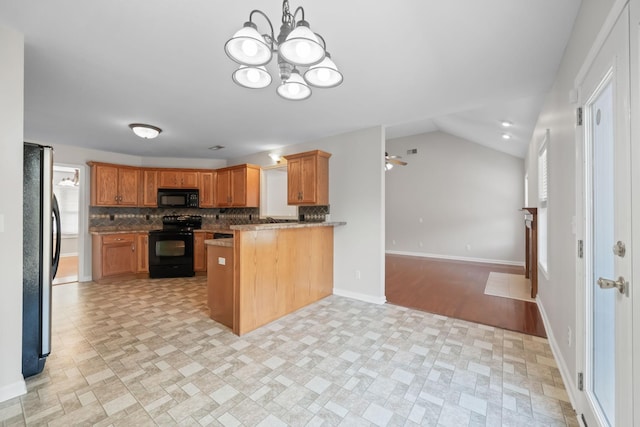 kitchen featuring baseboards, decorative backsplash, open floor plan, a peninsula, and black appliances