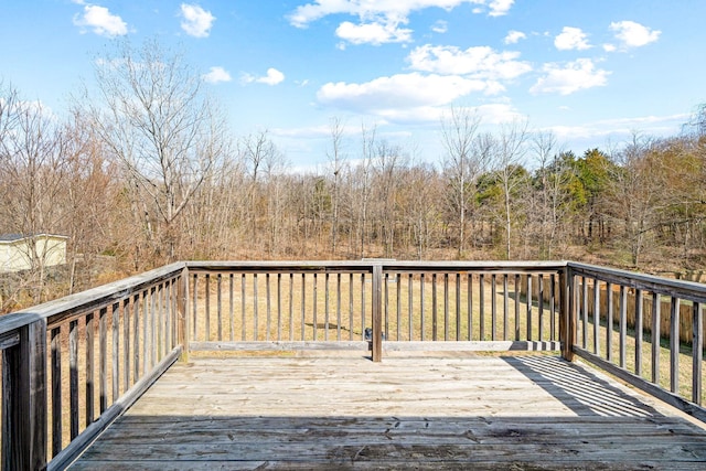 wooden deck with a wooded view