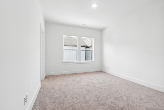 empty room featuring light colored carpet