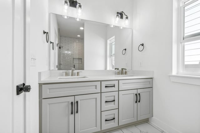 bathroom featuring vanity and a shower with shower door