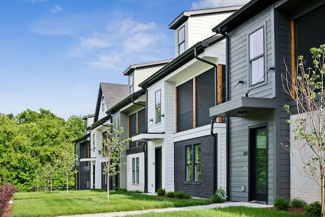 view of side of property with a yard