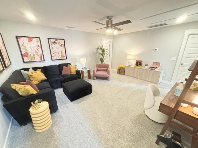 carpeted living room with ceiling fan