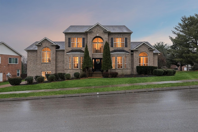 french country style house with a lawn