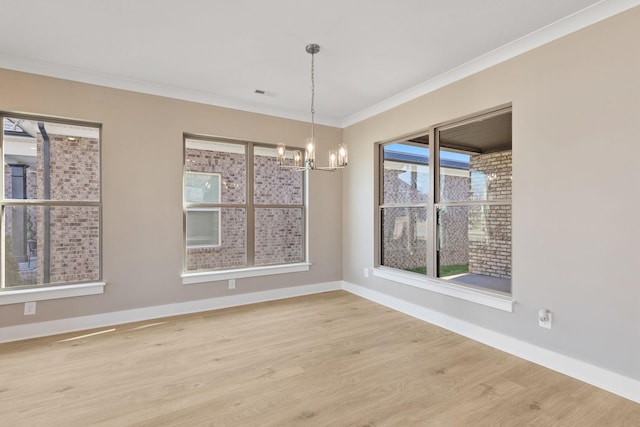 unfurnished dining area with crown molding, hardwood / wood-style floors, and a notable chandelier