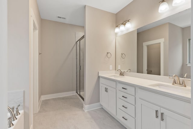 bathroom featuring vanity and independent shower and bath