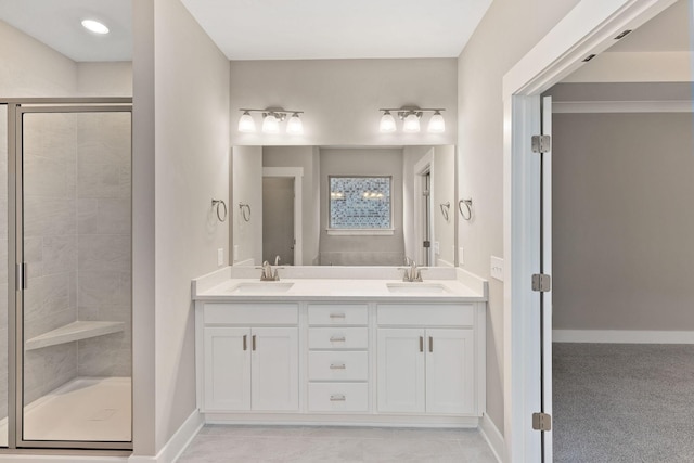 bathroom with vanity and a shower with door