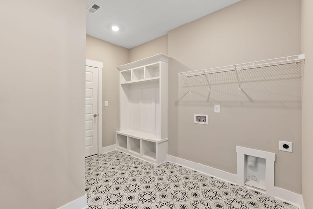 laundry area featuring electric dryer hookup, washer hookup, and light tile patterned floors