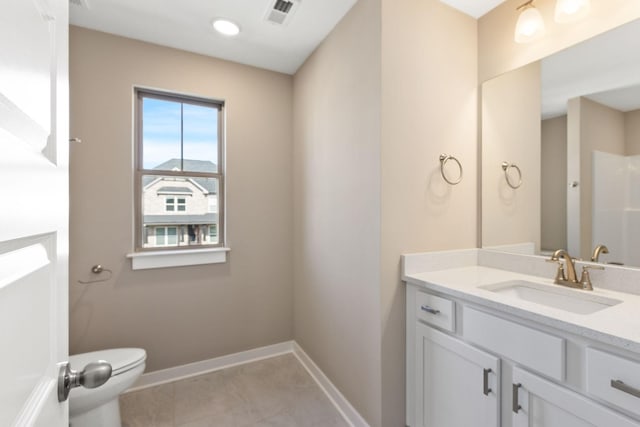 bathroom with vanity, tile patterned floors, and toilet