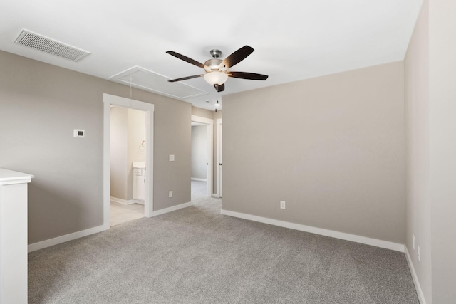 spare room featuring light colored carpet and ceiling fan