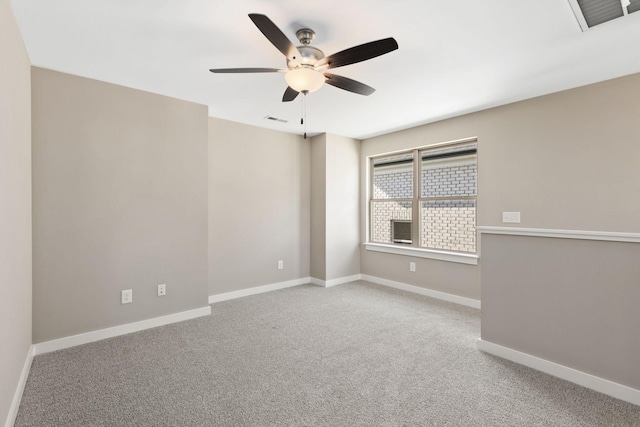 spare room featuring carpet and ceiling fan