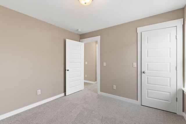 unfurnished bedroom featuring light carpet