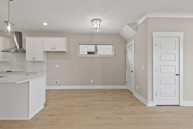 kitchen with white cabinetry, tasteful backsplash, wall chimney exhaust hood, and light wood-type flooring