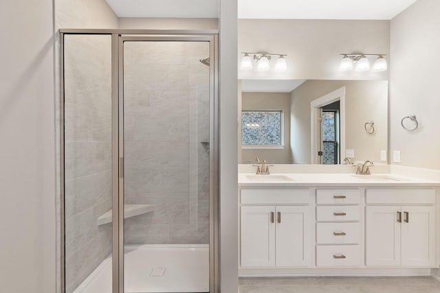 bathroom with vanity and a shower with door