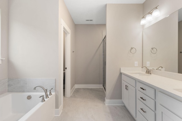 bathroom with vanity and independent shower and bath