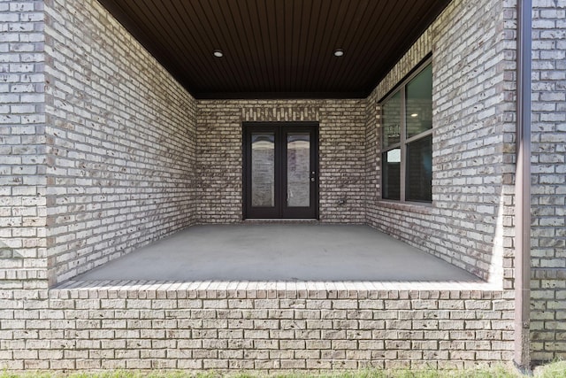 view of exterior entry featuring french doors