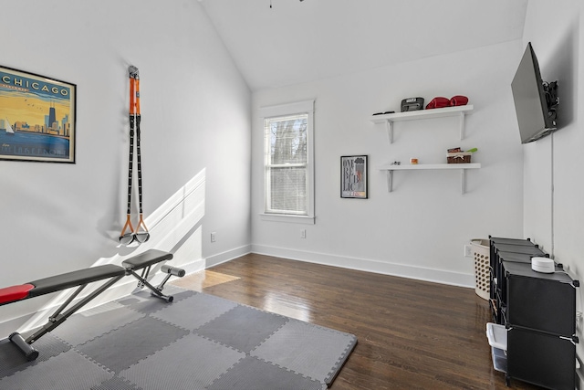 exercise area with vaulted ceiling and dark hardwood / wood-style floors