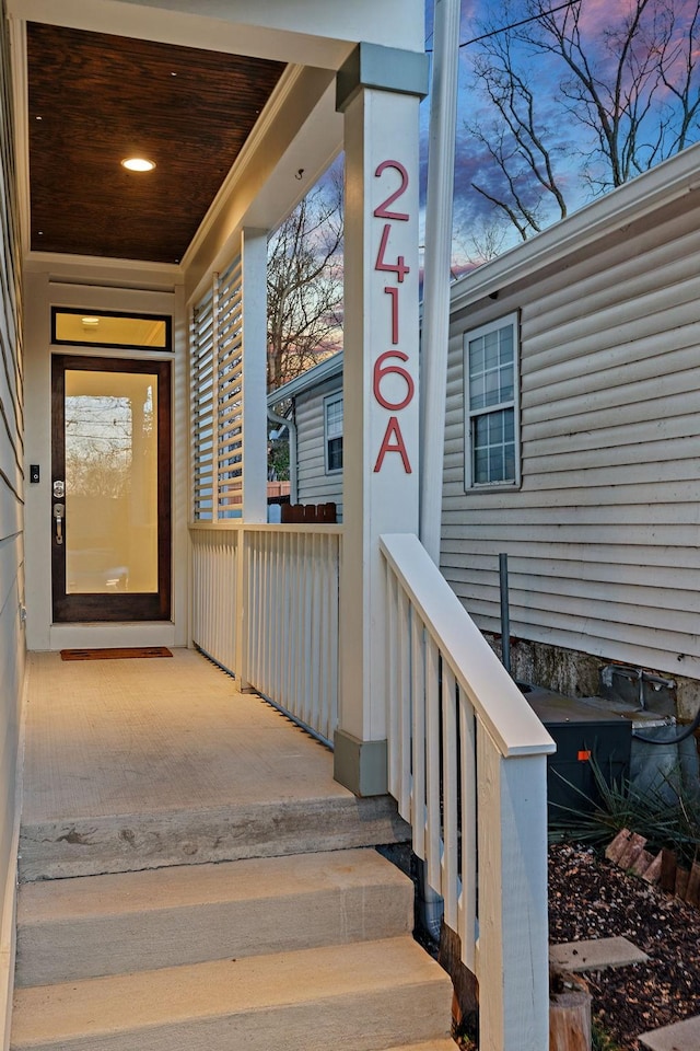 exterior entry at dusk with covered porch