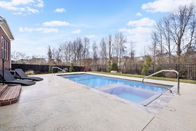 view of swimming pool featuring a hot tub and a patio area