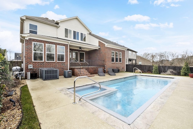 back of property featuring a fenced in pool, a patio, and cooling unit