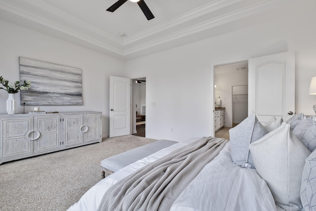 bedroom with connected bathroom, carpet floors, ornamental molding, ceiling fan, and a raised ceiling