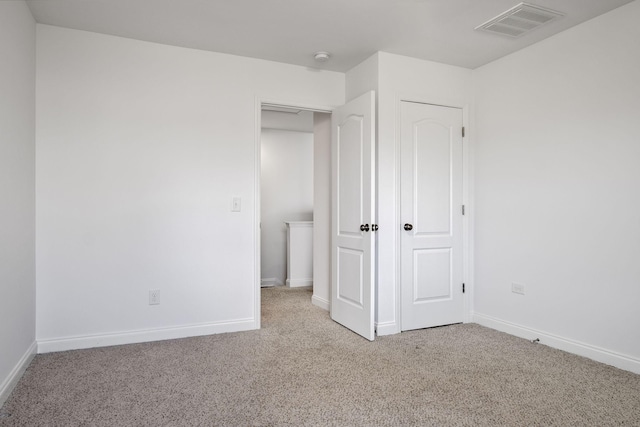 unfurnished bedroom featuring light colored carpet