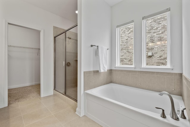 bathroom with tile patterned flooring and separate shower and tub