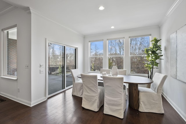 dining space featuring ornamental molding and dark hardwood / wood-style floors