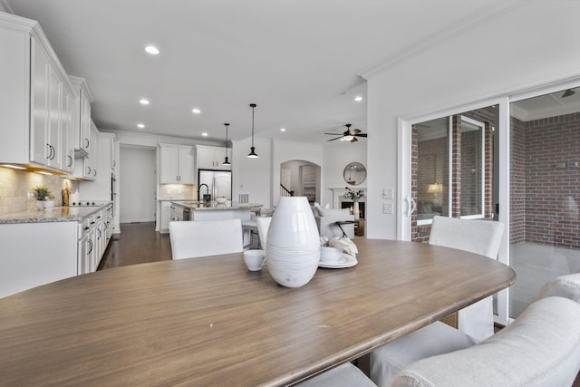 dining space featuring ornamental molding, dark hardwood / wood-style flooring, and ceiling fan