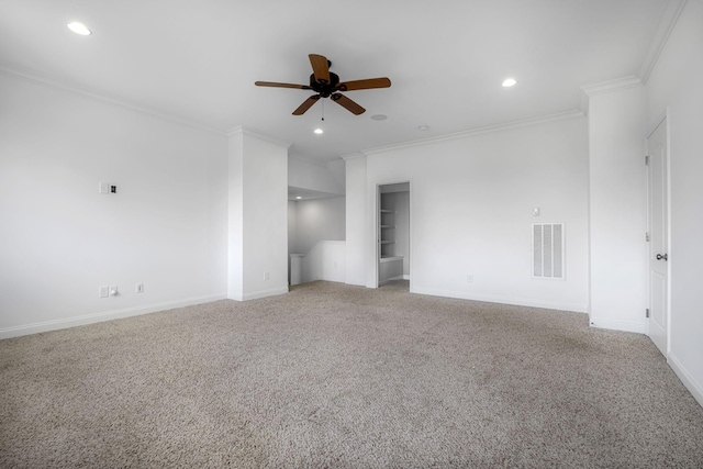 spare room featuring crown molding, built in features, ceiling fan, and carpet