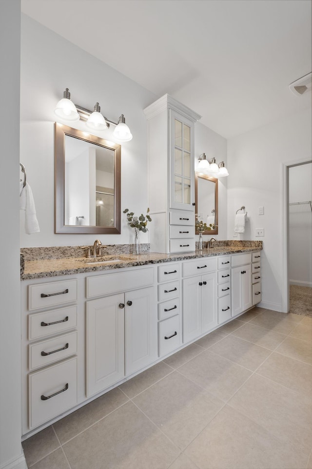 bathroom featuring tile patterned flooring and vanity