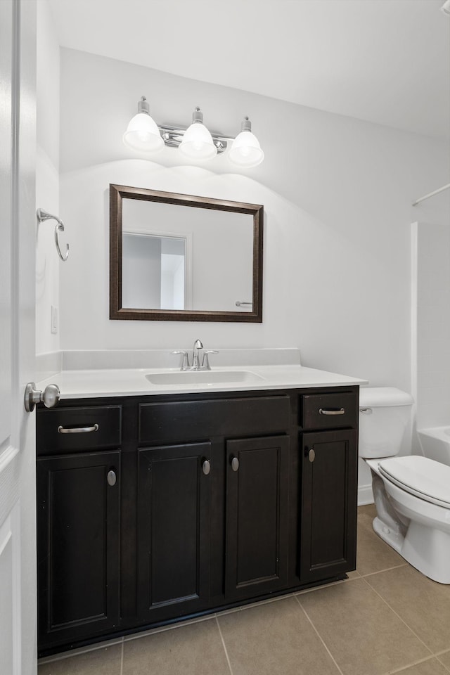 bathroom with tile patterned flooring, vanity, and toilet