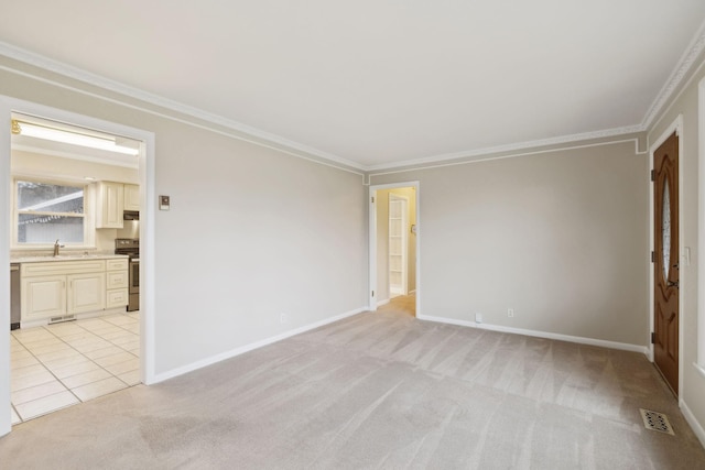 unfurnished room with crown molding, sink, and light colored carpet