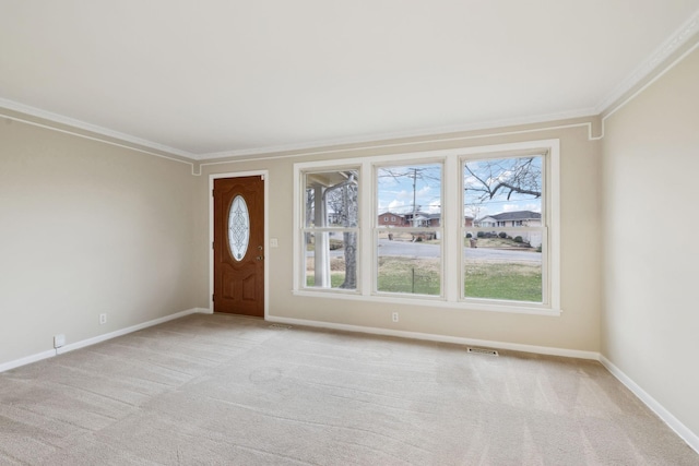 entrance foyer featuring crown molding and light carpet