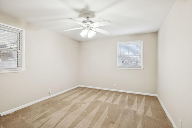 spare room featuring ceiling fan and light colored carpet