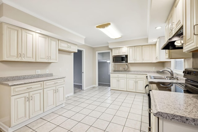 kitchen with sink, crown molding, light tile patterned floors, appliances with stainless steel finishes, and cream cabinets