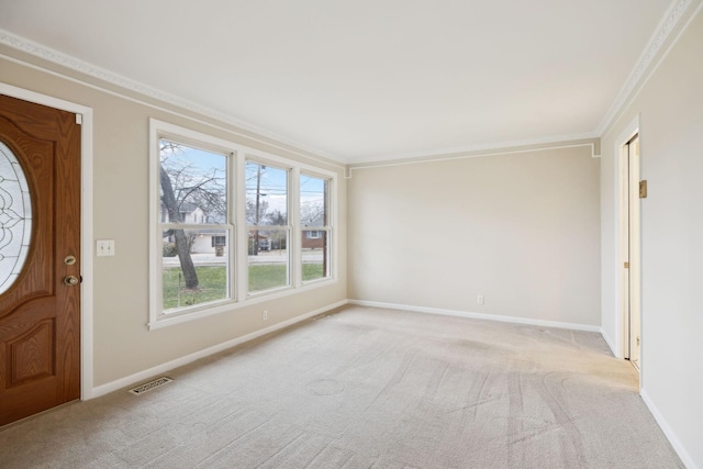 carpeted entrance foyer with crown molding