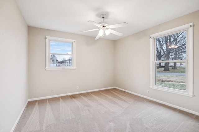 spare room with carpet and ceiling fan