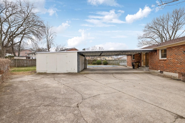 view of patio with a carport and a storage unit