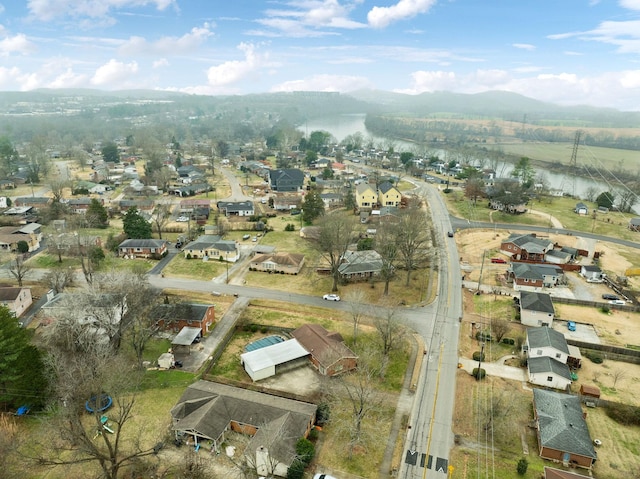 drone / aerial view featuring a water and mountain view