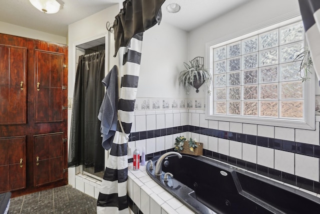 bathroom featuring independent shower and bath and a wealth of natural light