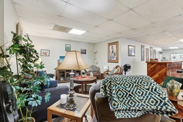 living room featuring a drop ceiling