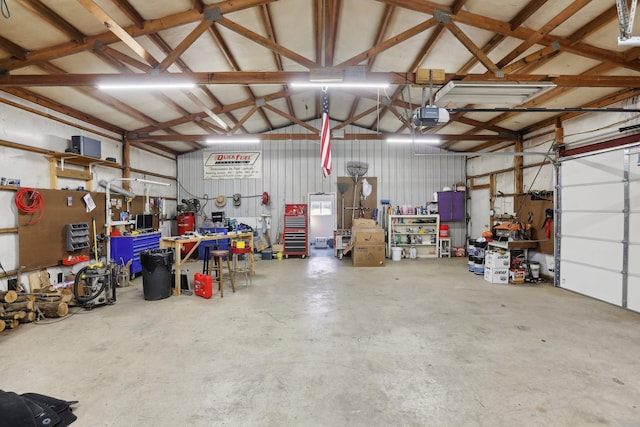 garage featuring a garage door opener and a workshop area