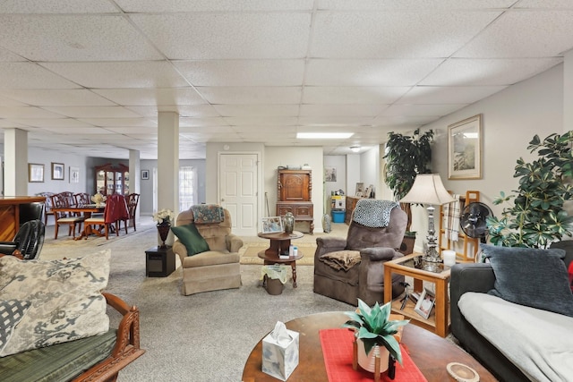 carpeted living room with a paneled ceiling