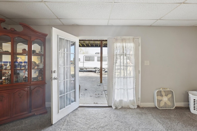 doorway with carpet floors and a paneled ceiling