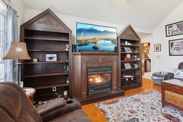 living room with light hardwood / wood-style floors and vaulted ceiling