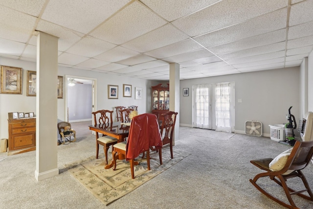 dining room featuring carpet flooring, a paneled ceiling, and french doors