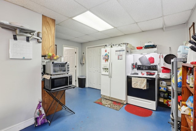 kitchen with a drop ceiling and white appliances