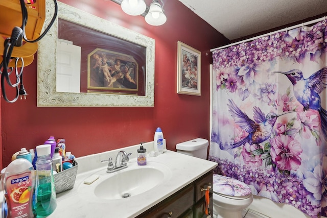 bathroom with vanity, a textured ceiling, toilet, and walk in shower